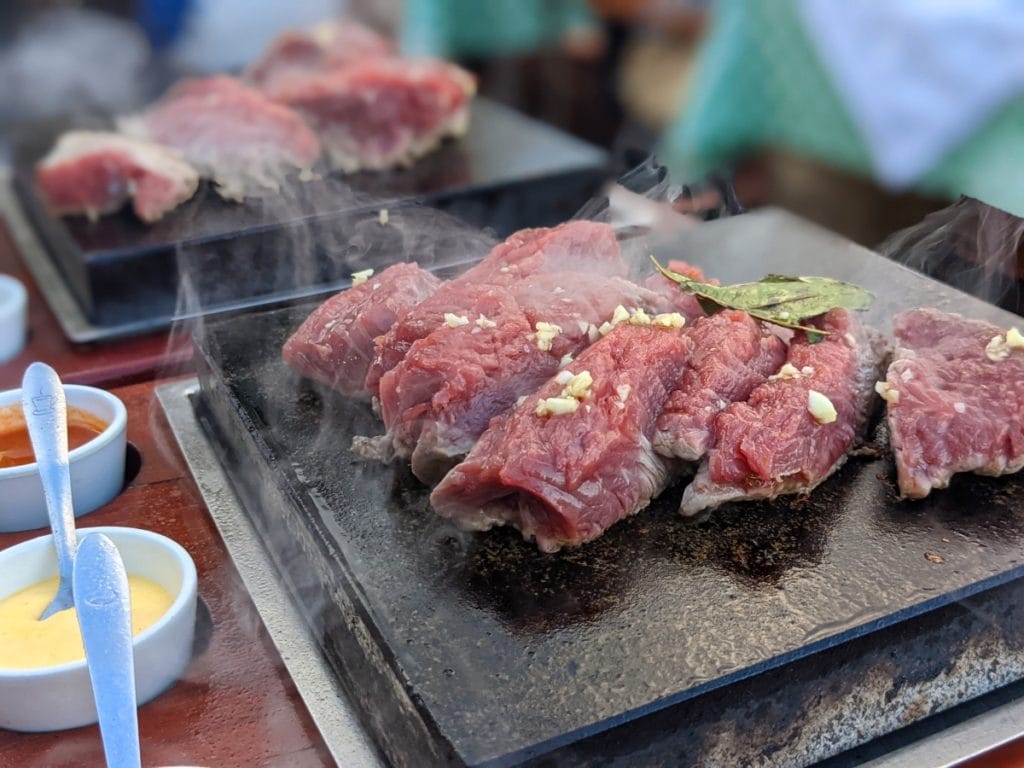 steak with garlic and sauces on the hot stone in casal da penha